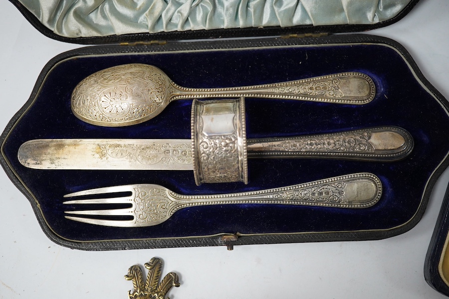 A cased Victorian engraved silver four piece christening set, by William Hutton & Sons Ltd, London, 1895, comprising a spoon, knife, fork and napkin ring, together with a cased set of six silver teaspoons, a cased pair o